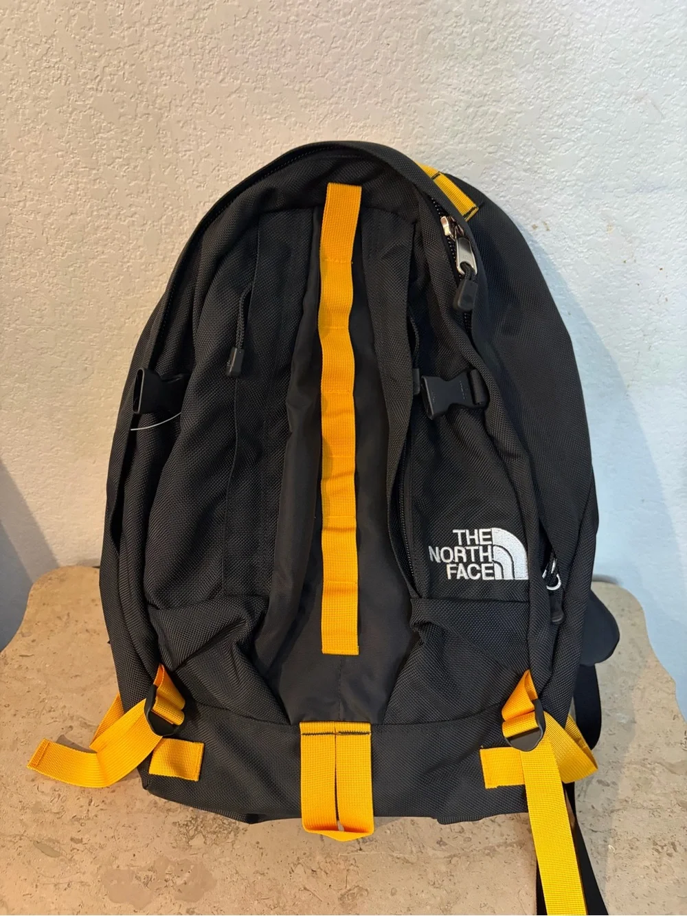 The North Face Black Backpack with Yellow Accents